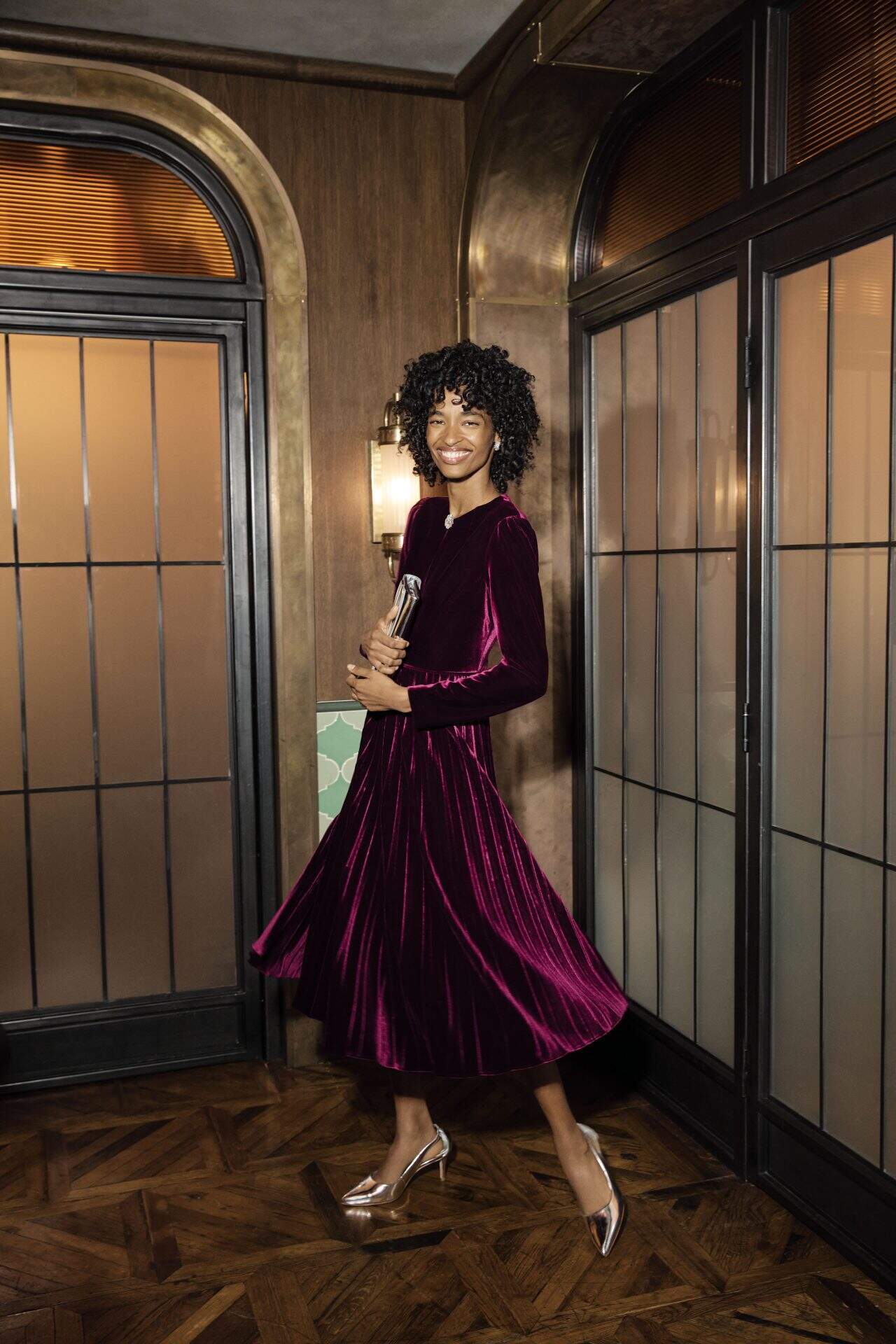 Elegant woman in a deep purple velvet dress at Victoria Leeds shopping centre.
