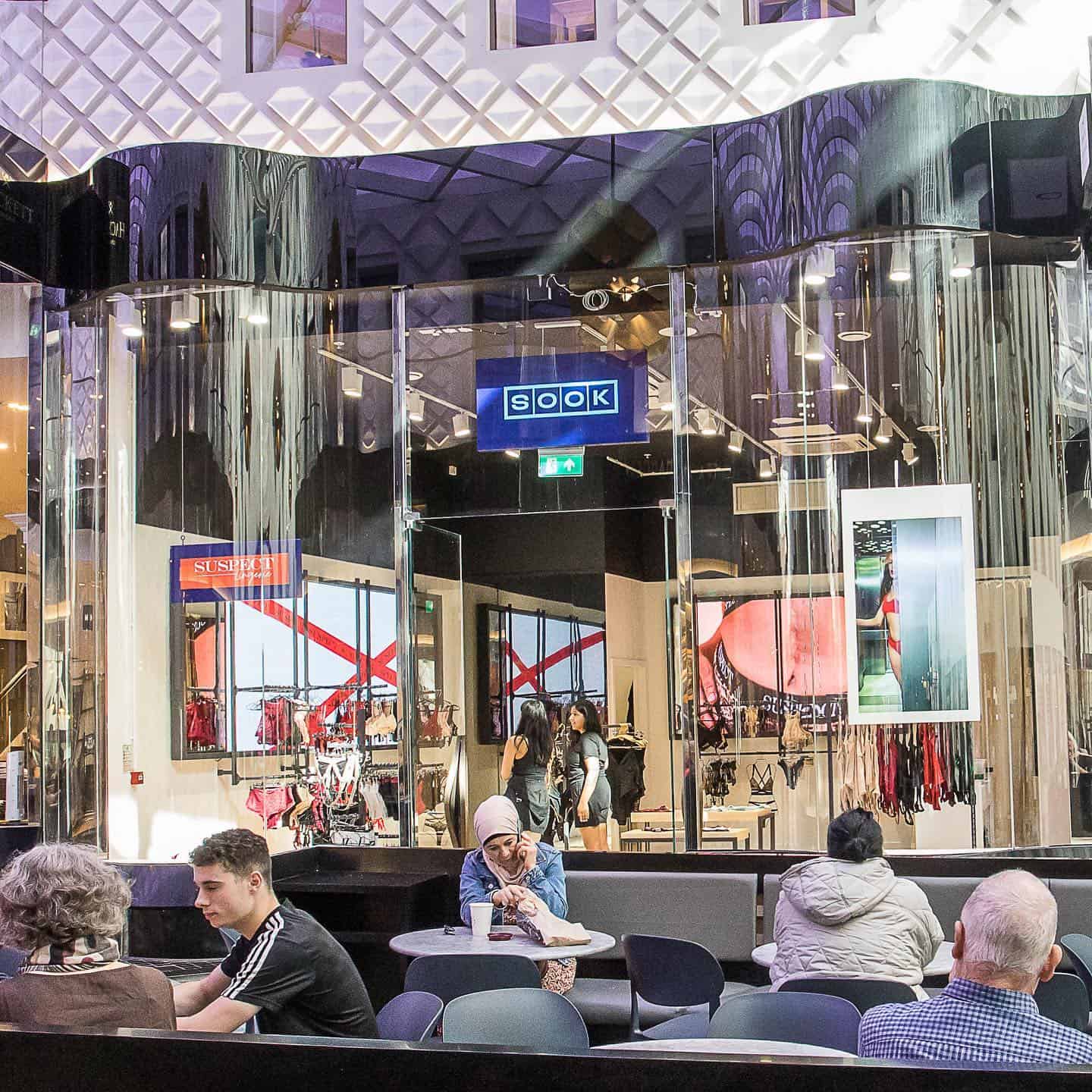 Elegant shopping mall with modern design and luxury brands.