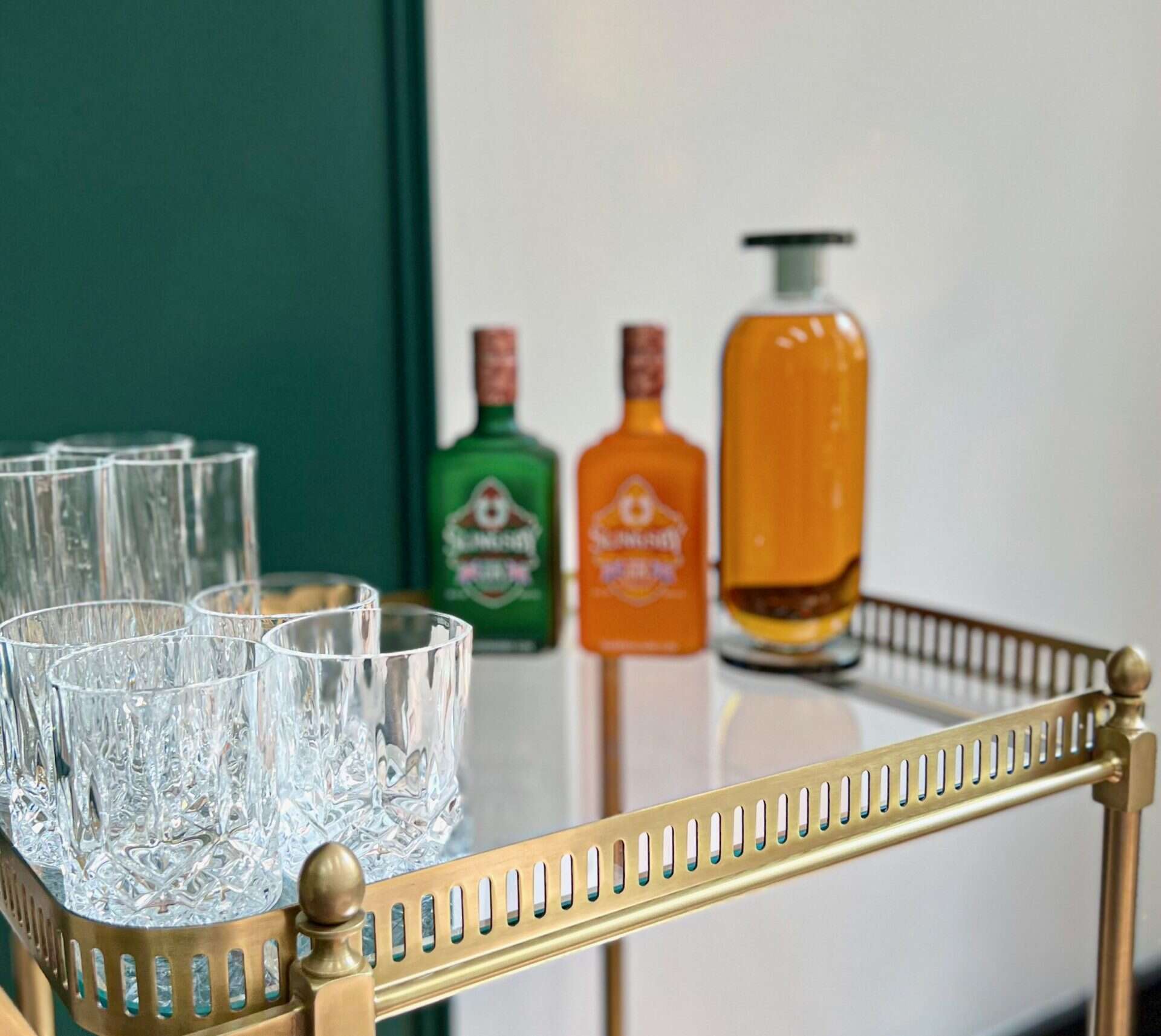 Stylish bar with colourful spirits and crystal glasses, perfect for festive parties.