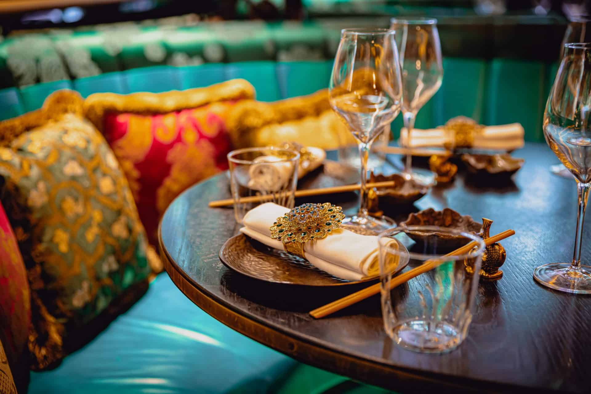 Elegant table setting with glasses and decorative elements for festive celebrations.