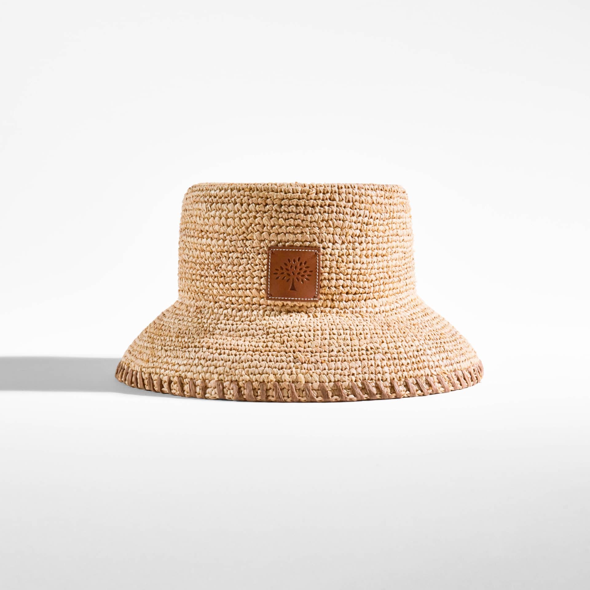 Woven straw sun hat perfect for summer picnics and outdoor leisure.