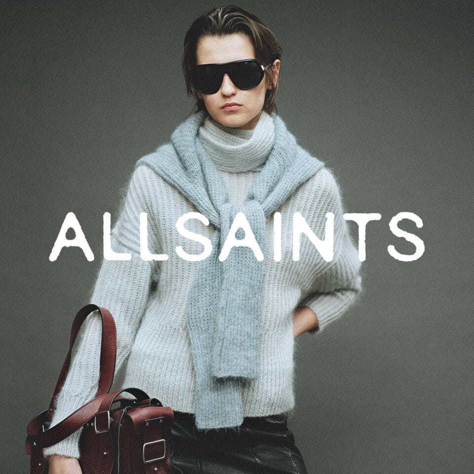 Fashionable woman in oversized sweater and sunglasses for AllSaints.