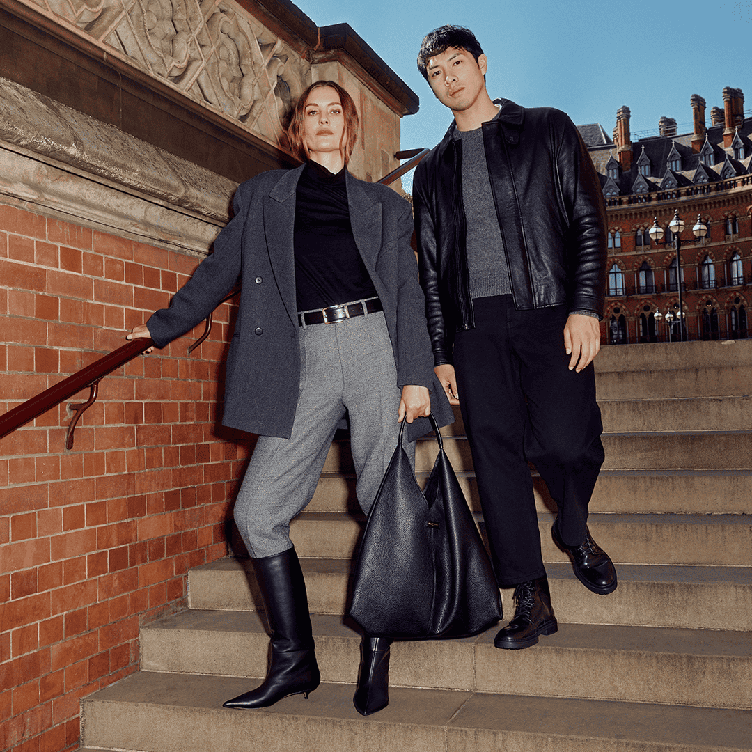 Fashionable models in winter outfits from Victoria Leeds' Winter 23 Collection on city stairs.