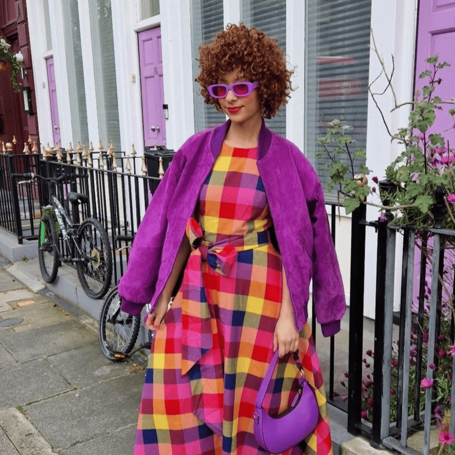 Stylish woman in colourful check dress with purple accessories in Leeds.