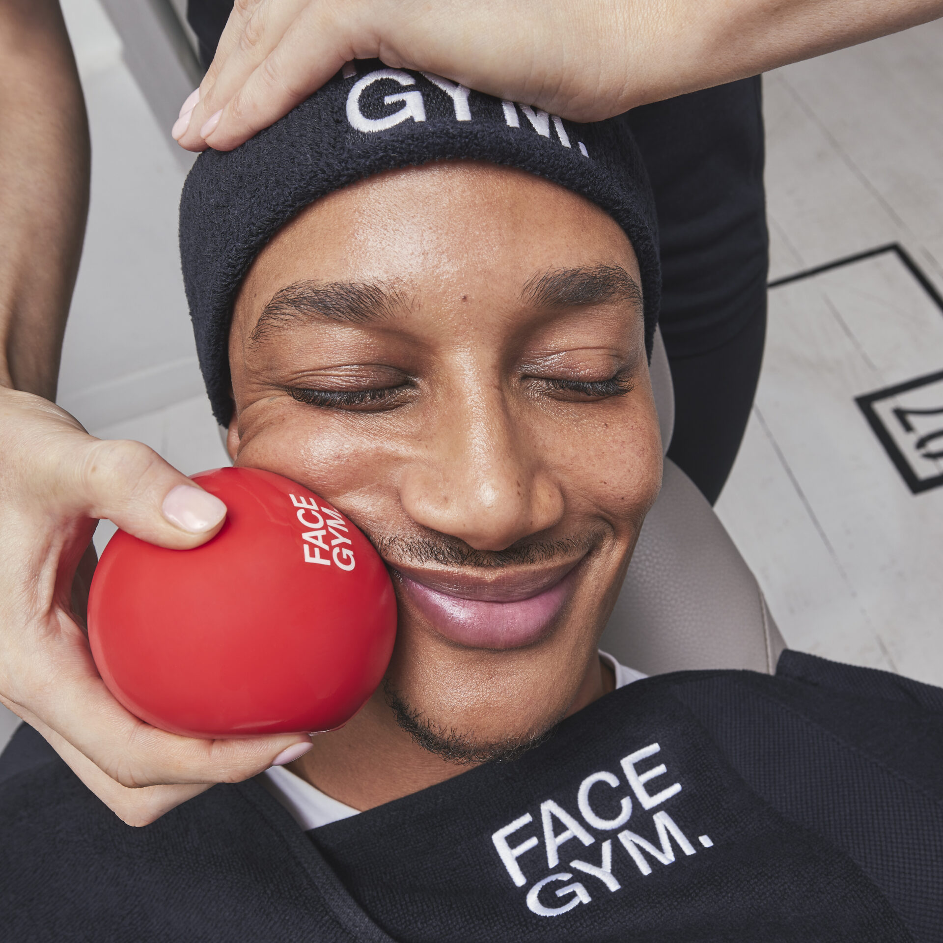 Man receiving facial massage with FaceGym tools at Victoria Leeds.