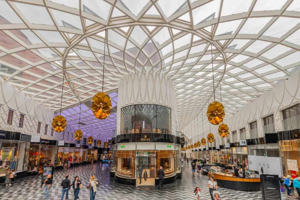 Victoria Leeds shopping centre interior with modern architecture and shoppers.