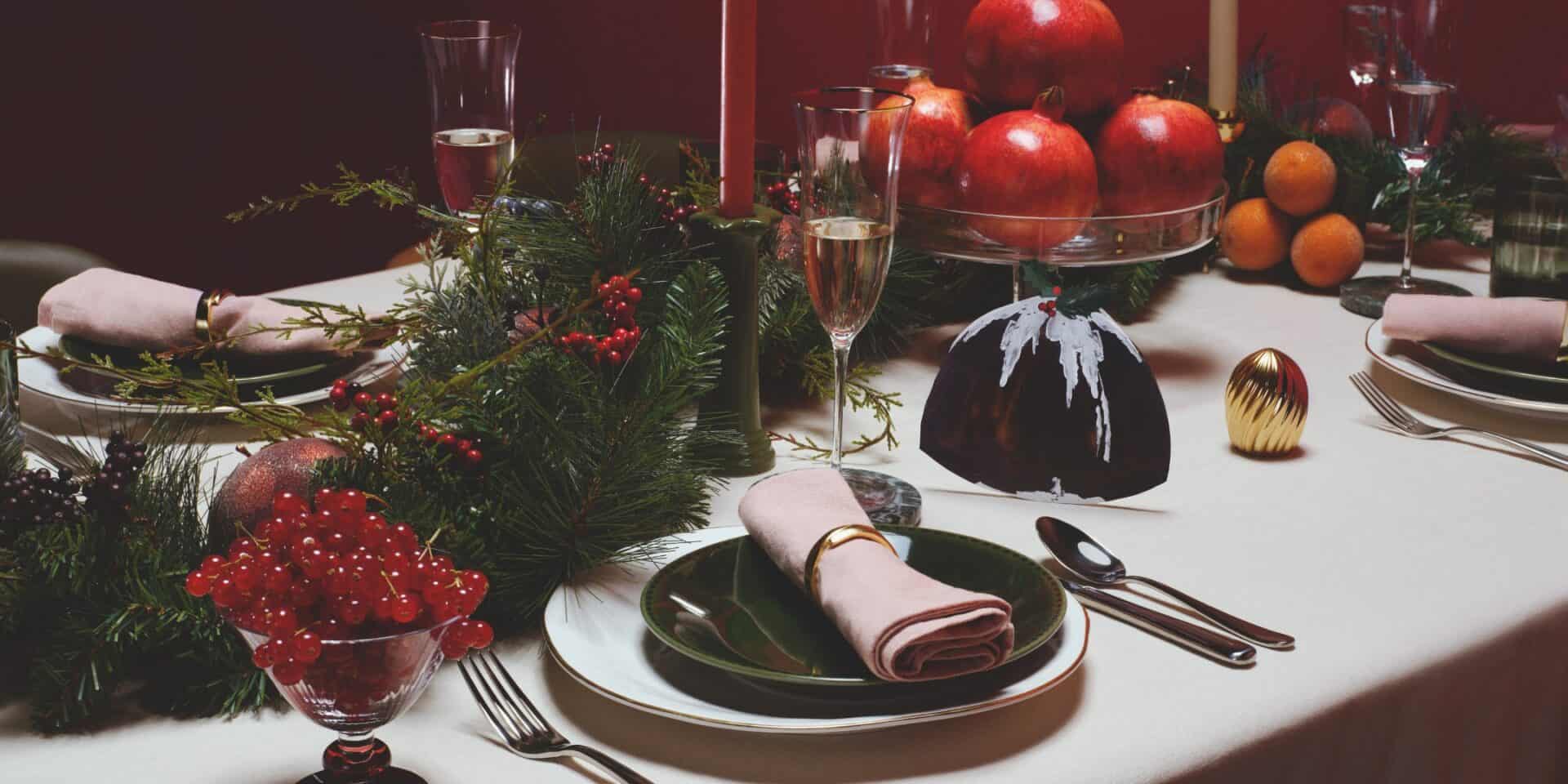 Elegant Christmas table setting with festive decorations and fine china.