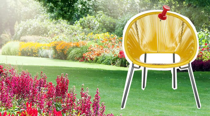 Stylish yellow outdoor chair in a lush garden setting.