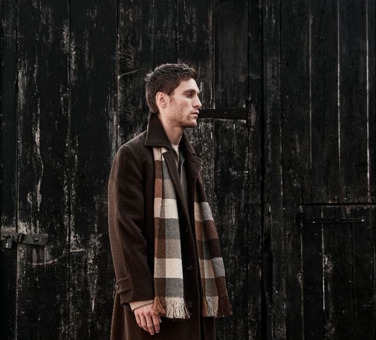 Men's fashion in dark winter coat with checkered scarf at Victoria Leeds.