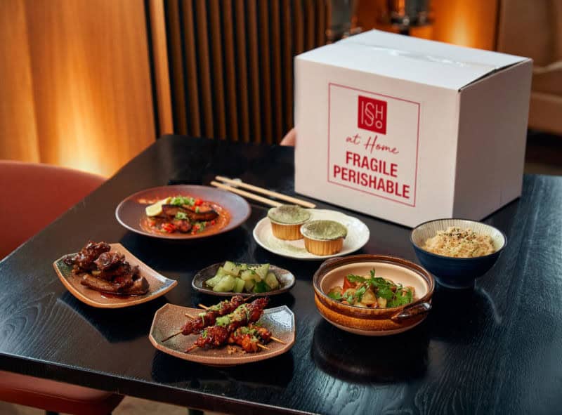 At home meal kit with Asian dishes and ingredients in a box.