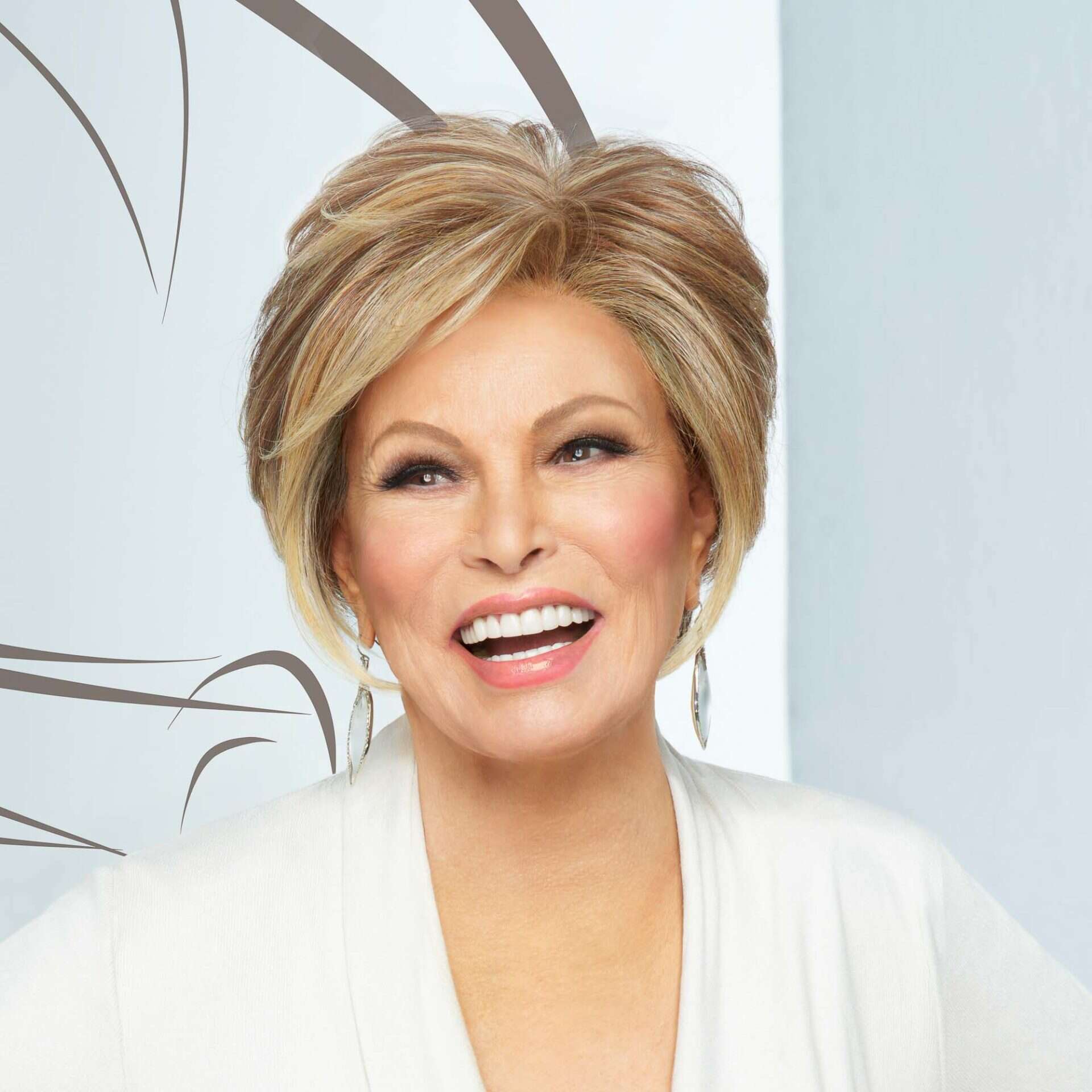 Elegant woman with styled blonde hair smiling confidently at Victoria Leeds Hair Plus.