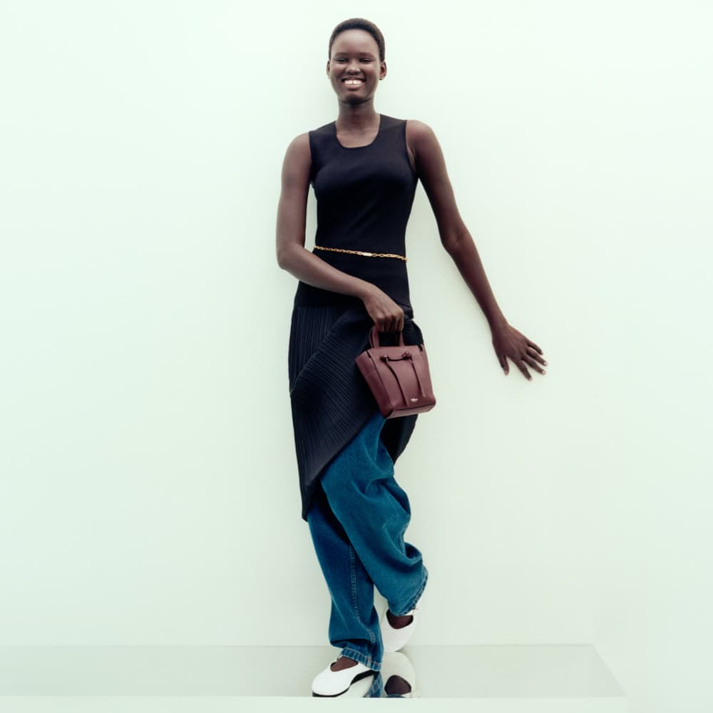 Elegant woman wearing Mulberry handbag and stylish outfit at Victoria Leeds.