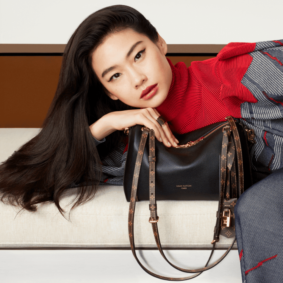 Elegant woman with Louis Vuitton handbag at Victoria Leeds.