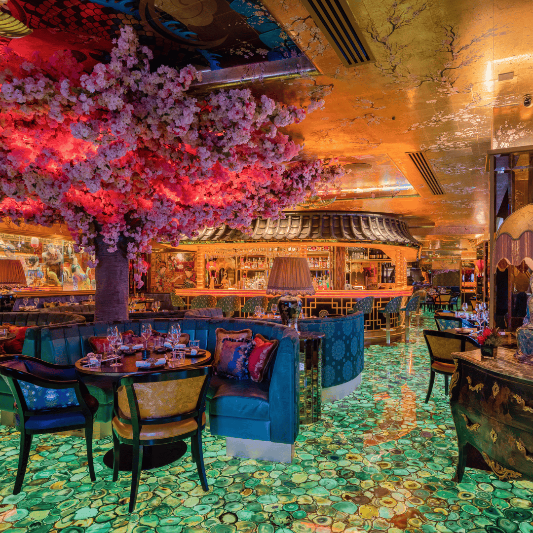 Elegant interior of The Ivy Asia at Victoria Leeds with vibrant decor and lush floral arrangements.