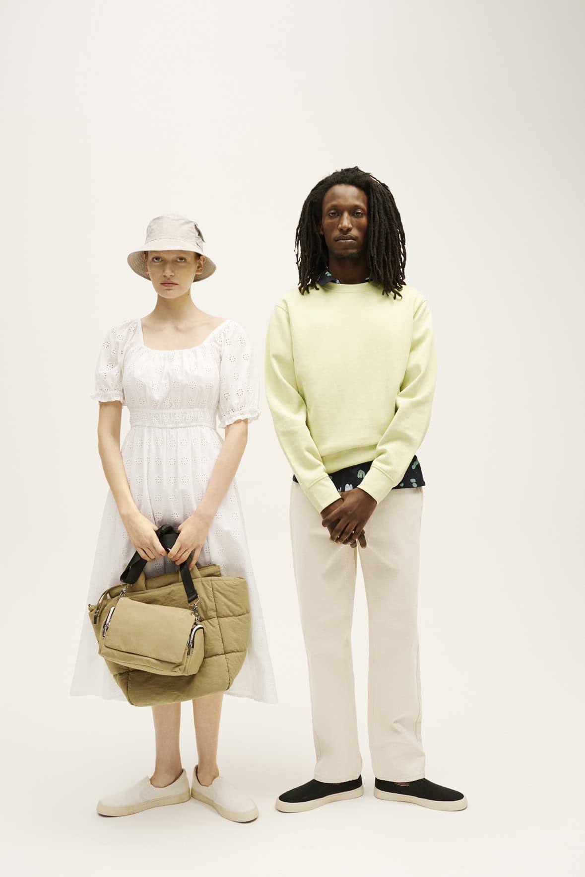 Two models showcasing effortless spring/summer fashion with John Lewis, featuring light colours and.