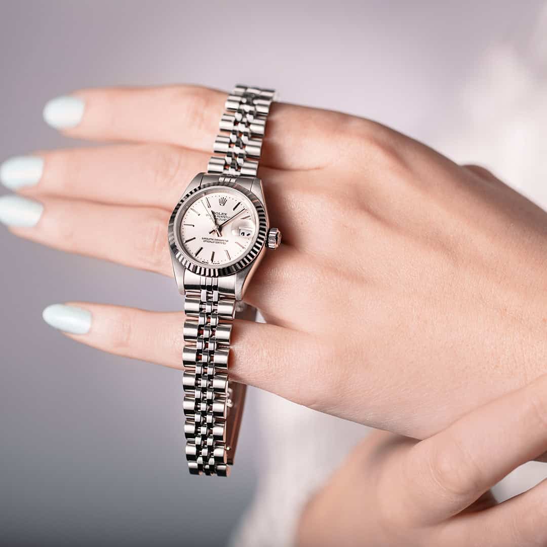 Close-up of a luxury silver watch on a woman's wrist at Victoria Leeds.