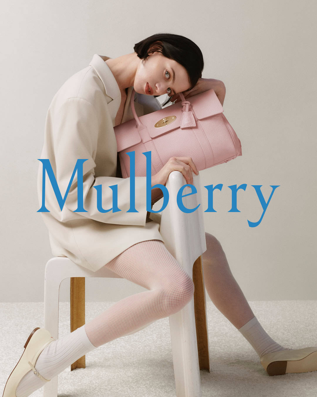Woman with pink Mulberry Bayswater bag, celebrating 20 years of the iconic design.