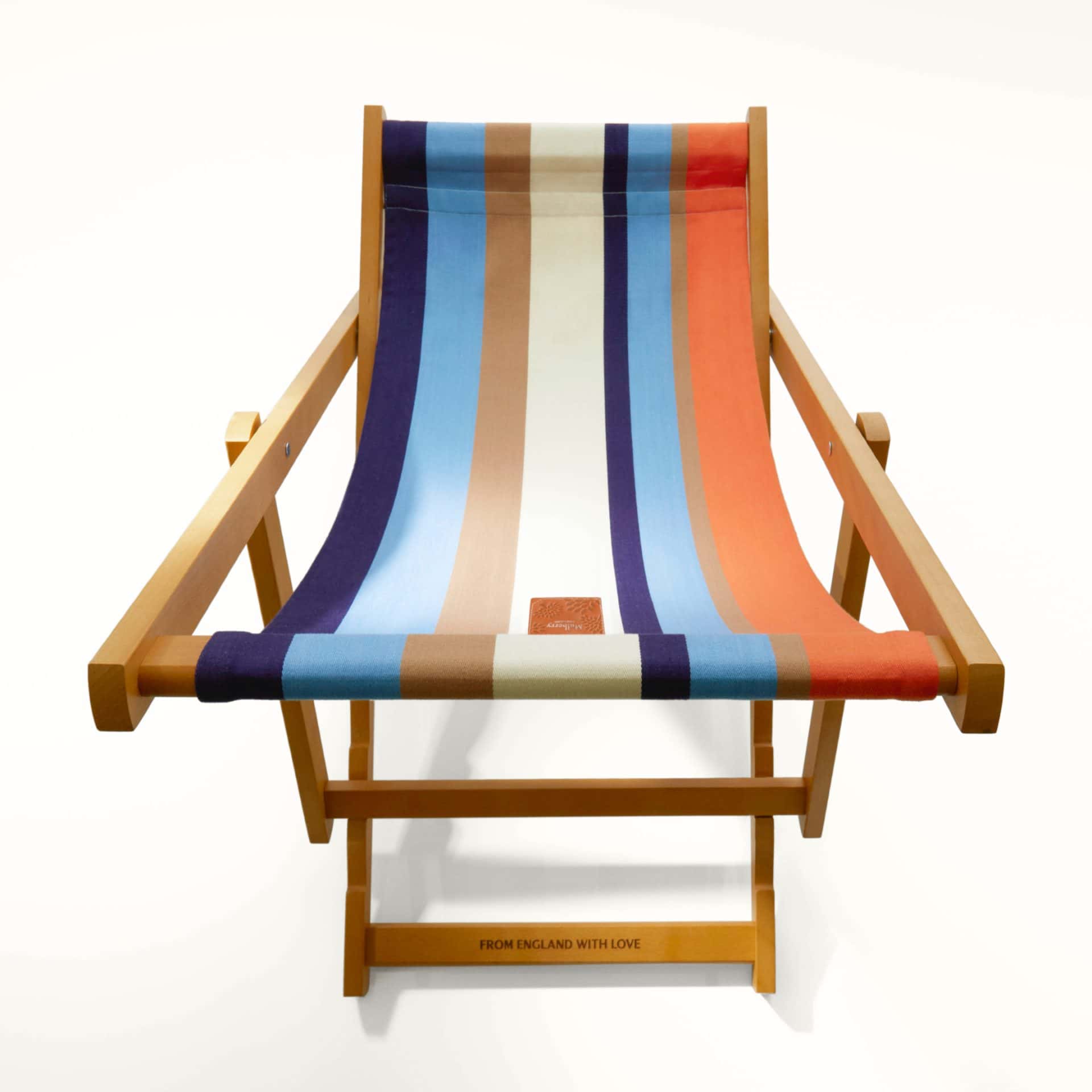 Stylish wooden picnic chair with colourful striped fabric for summer outdoor lounging.