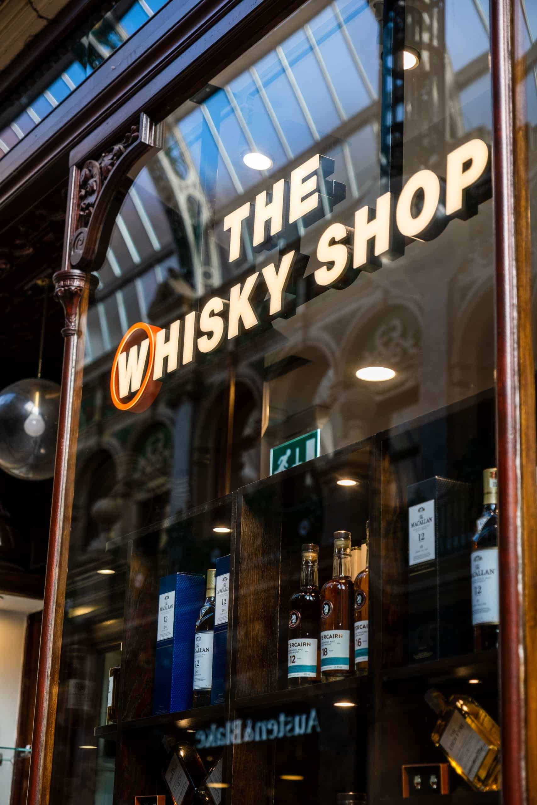 Exterior view of The Whisky Shop at Victoria Leeds showcasing premium whisky bottles in display wind.