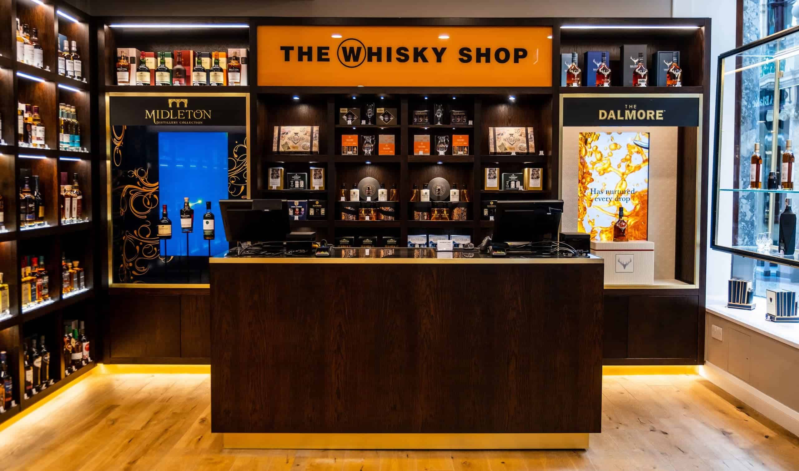 Brightly lit whisky shop at Victoria Leeds with extensive selection of spirits.