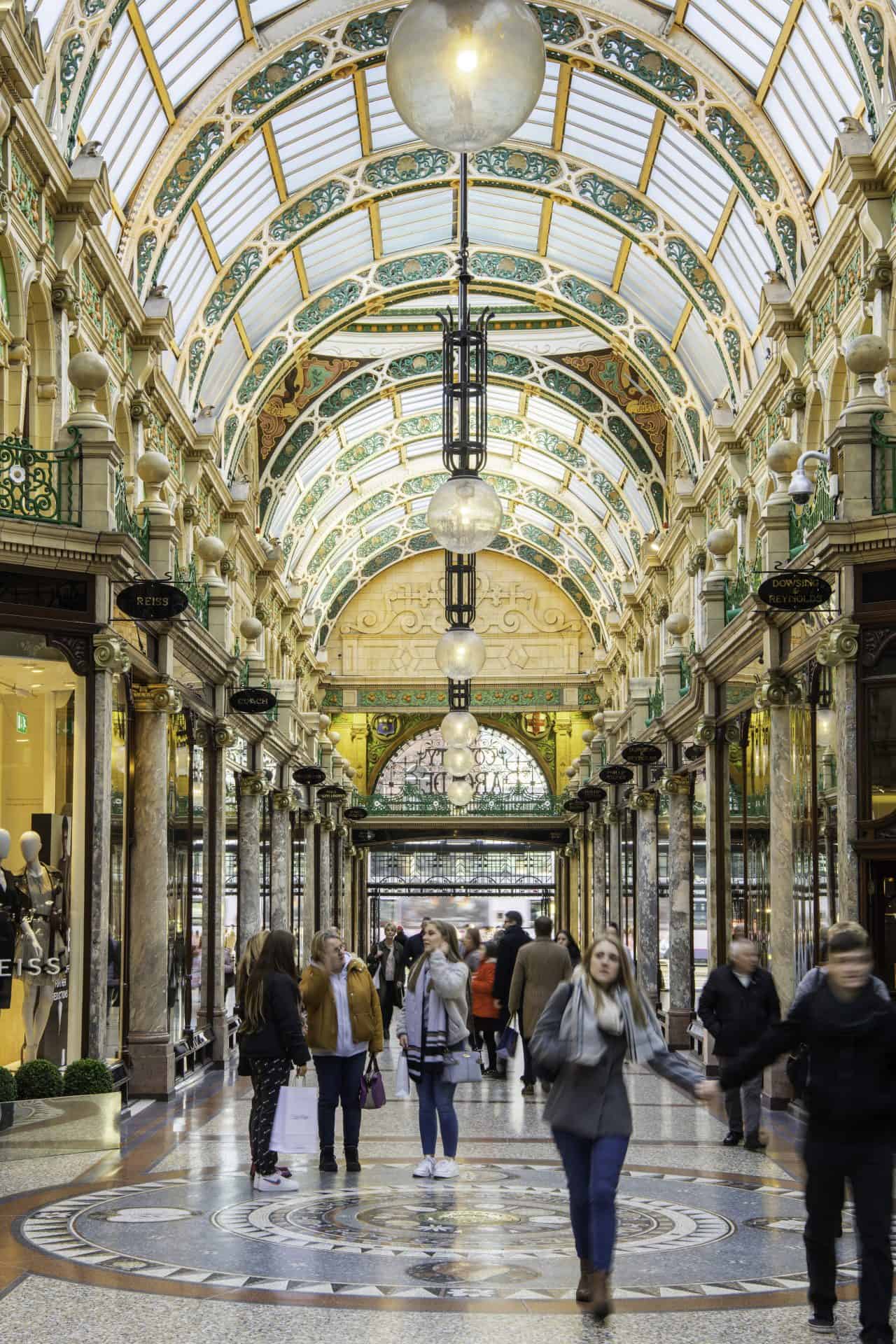Victoria Leeds shopping arcade with ornate glass ceiling and elegant architecture.