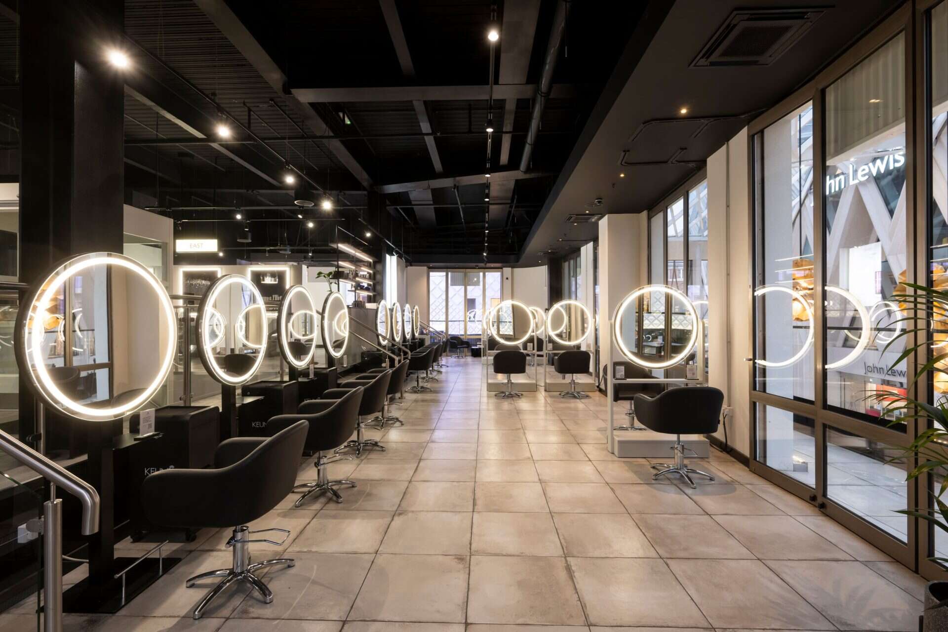 Illuminated mirrors and styling chairs in a contemporary beauty salon at Victoria Leeds, perfect for.