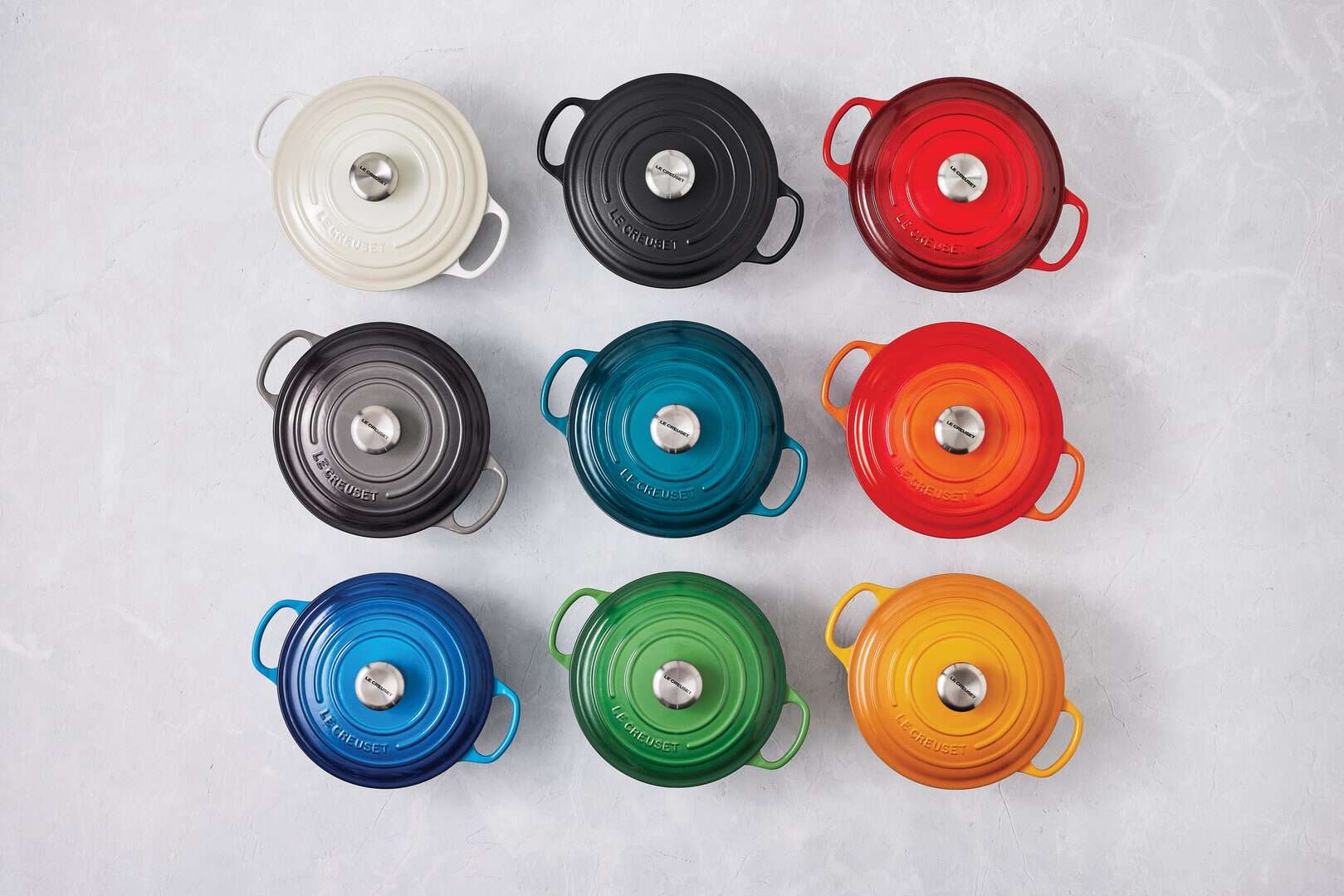 Vibrant Le Creuset pots in various colours displayed at John Lewis Leeds, perfect for stylish and fu.