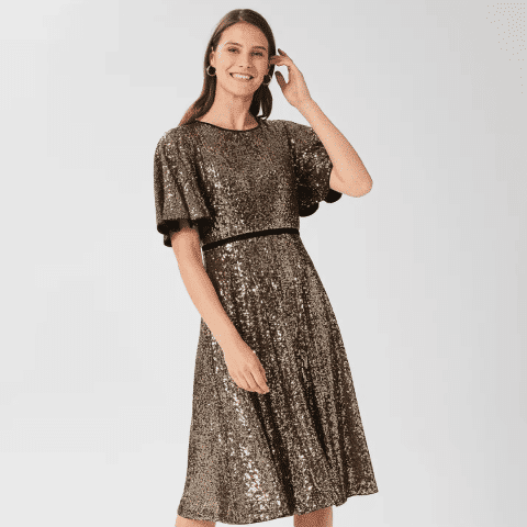 Woman in sparkling gold dress for New Year's Eve party at Victoria Leeds.