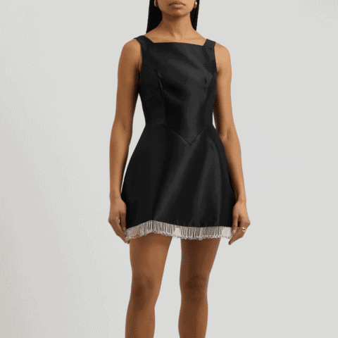 Elegant black cocktail dress with silver fringe detail, perfect for festive celebrations.