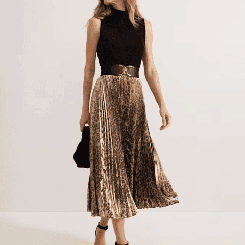 Elegant leopard print midi skirt paired with a chic black sleeveless top.
