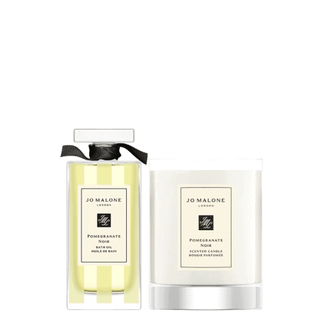 Pomegranate Noir scented candle and bath oil for relaxing self-care routines.
