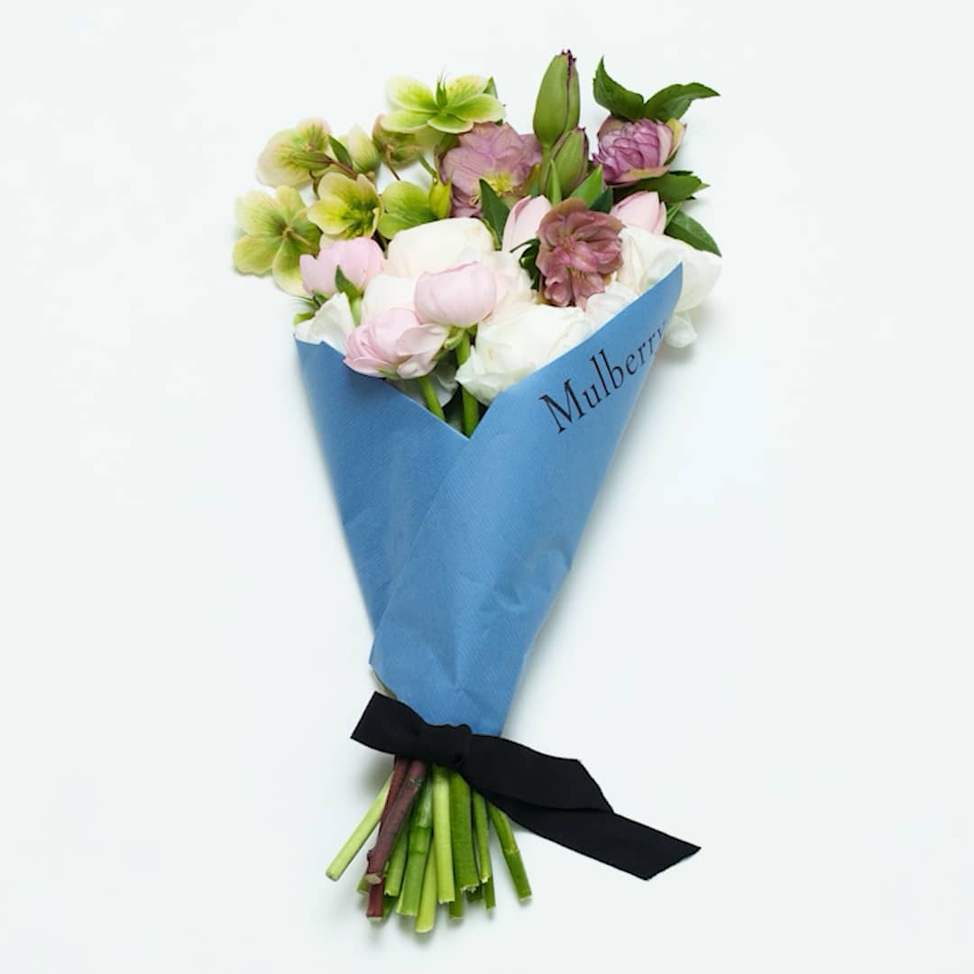 Beautiful mixed pastel flowers wrapped in blue paper with "Mulberry" label.