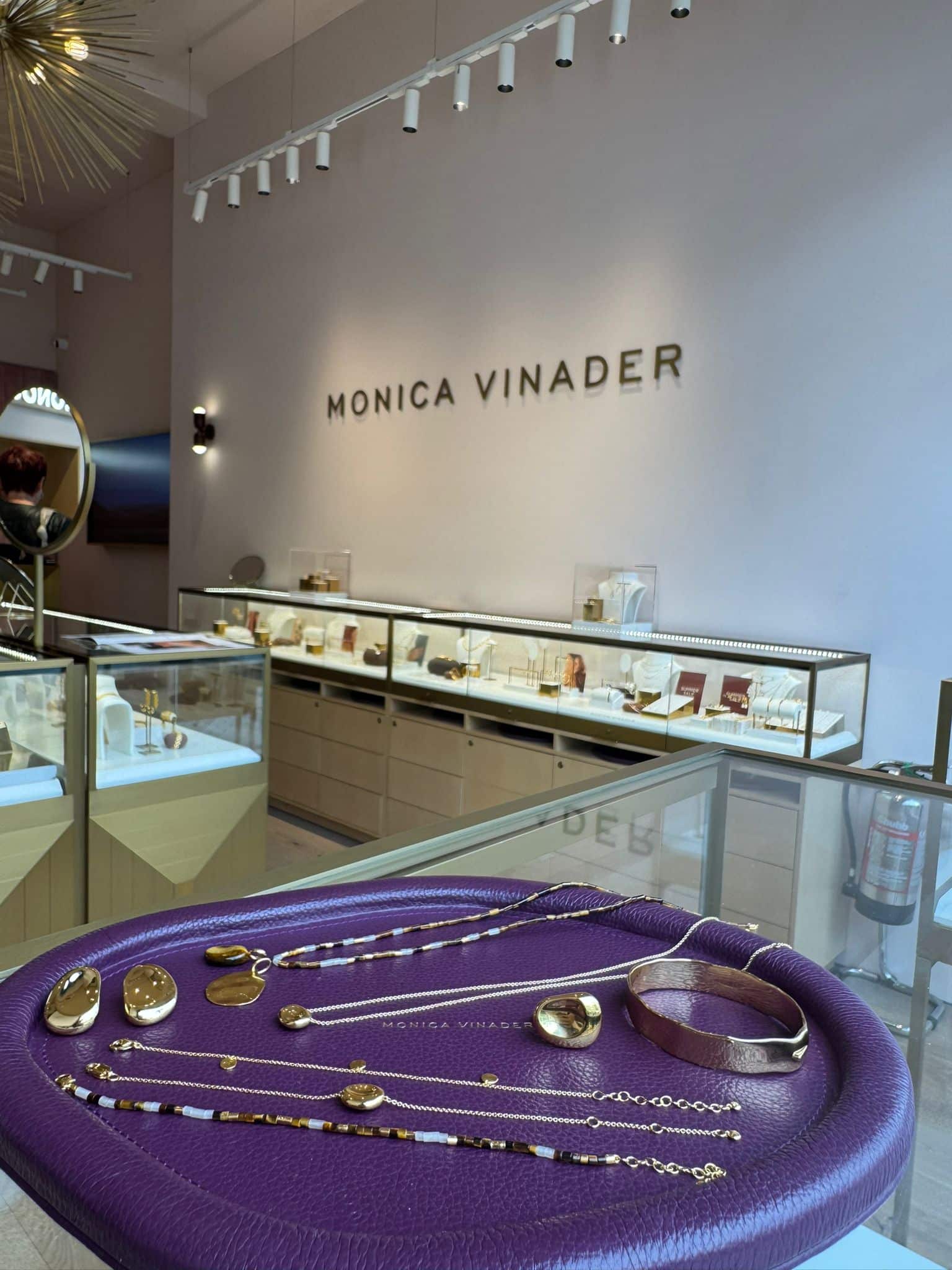 Jewelry display at Monica Vinader store in Victoria Leeds, showcasing elegant gold and silver access.