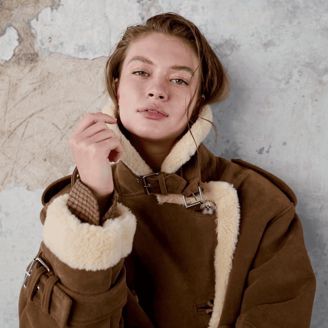 Young woman in cozy brown shearling jacket at Victoria Leeds shopping centre.