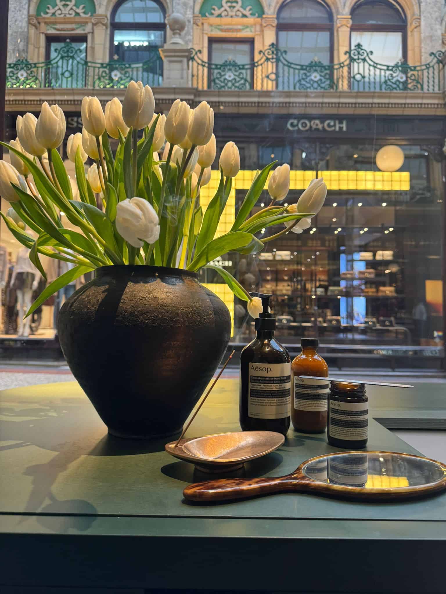 Elegant white tulips in a black vase at Victoria Leeds.