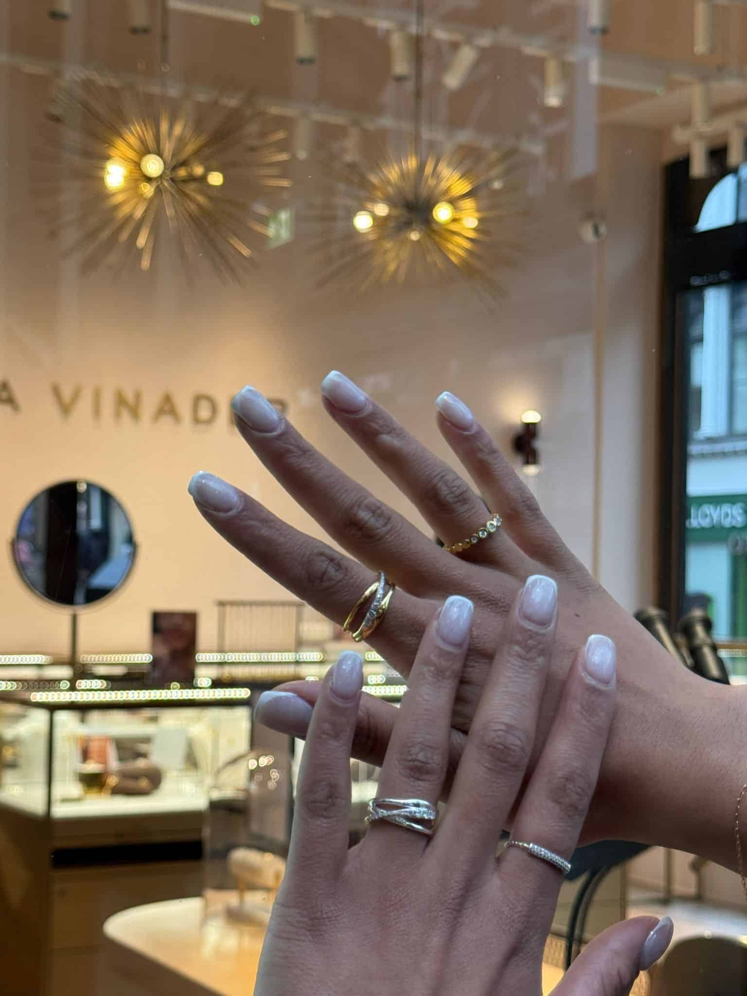 Elegant hand with multiple rings showcasing jewelry at Victoria Leeds.