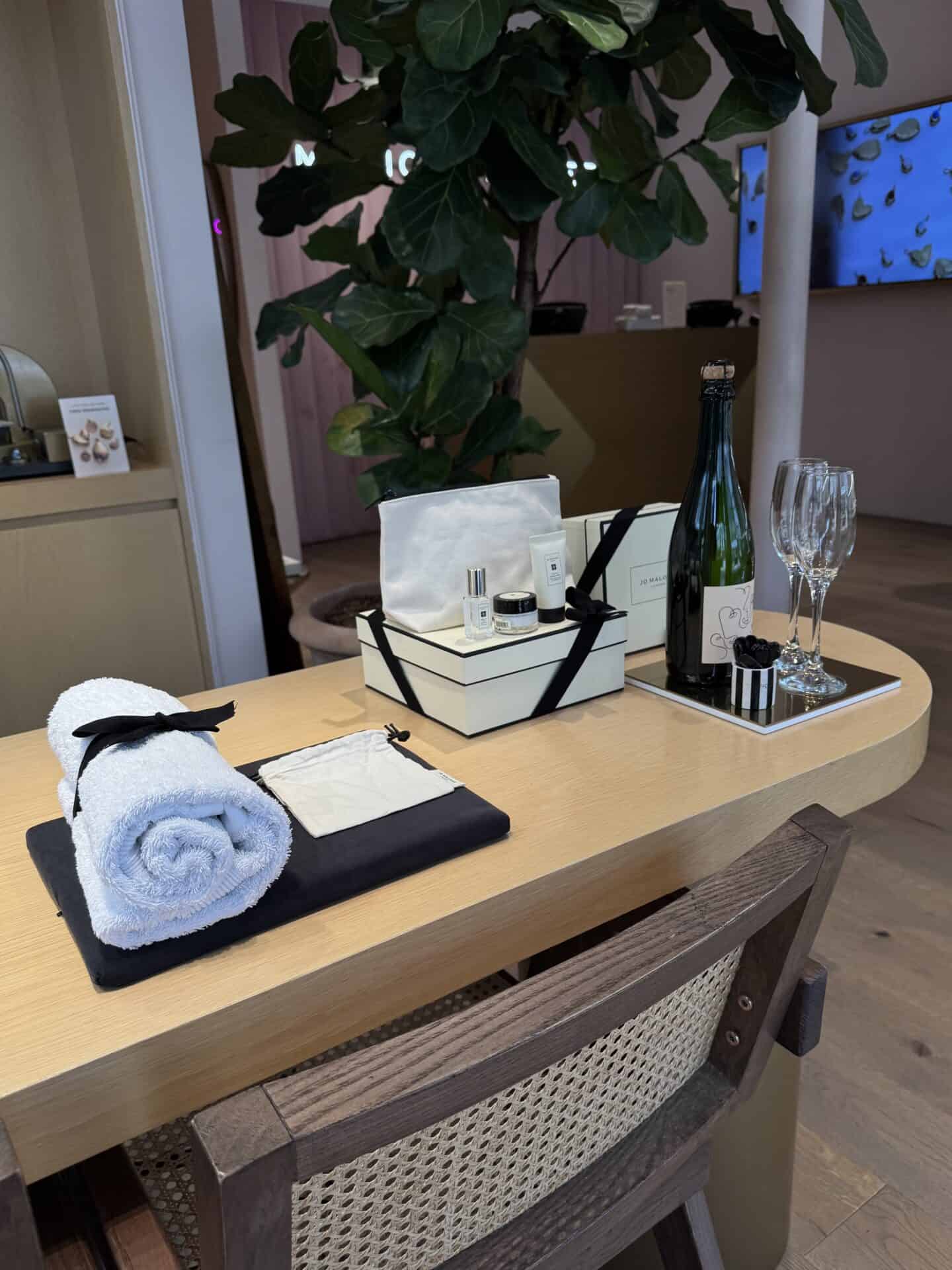 Elegant table with champagne, skincare, and event decor at Victoria Leeds.