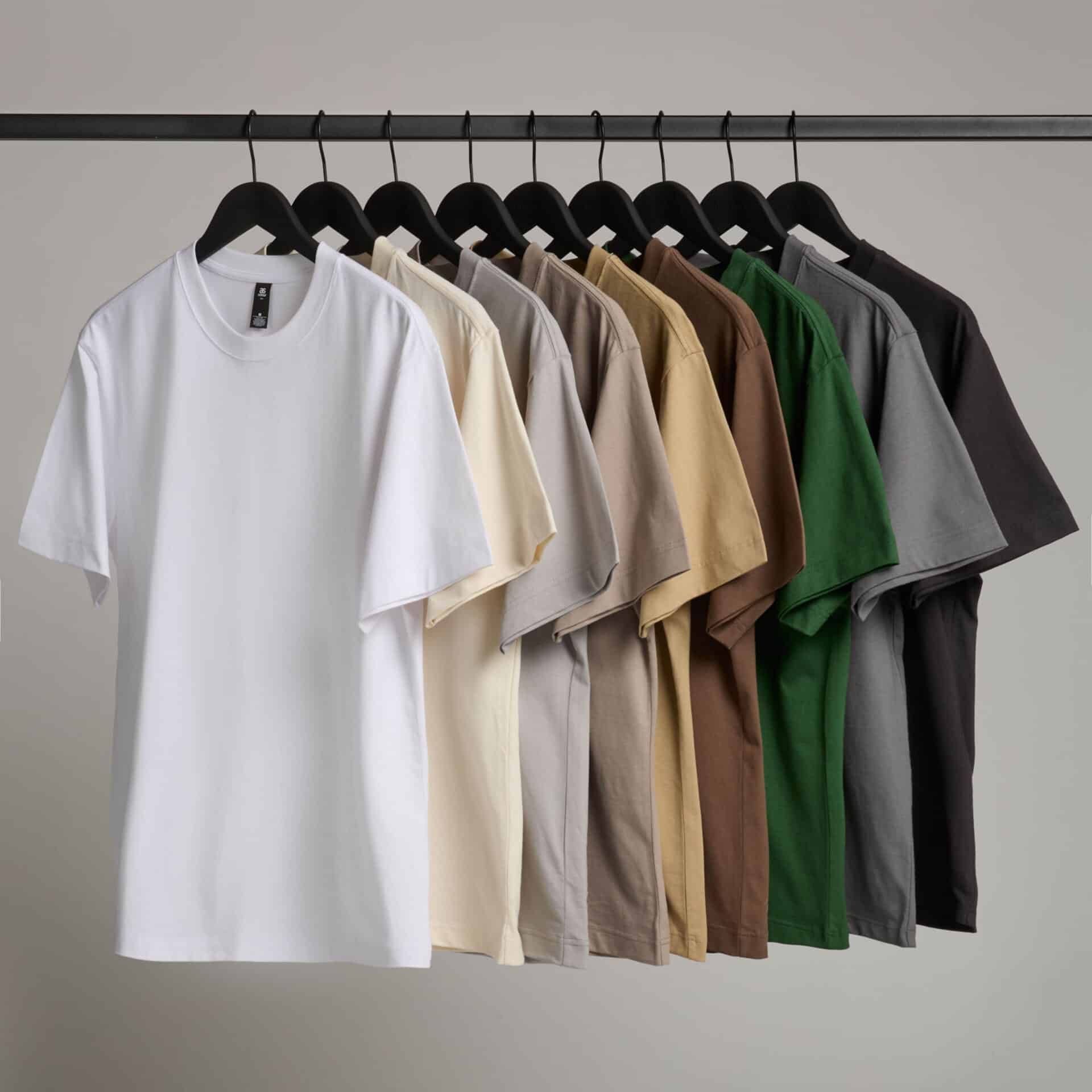 Classic white T-shirt displayed on a hanger, versatile and comfortable.