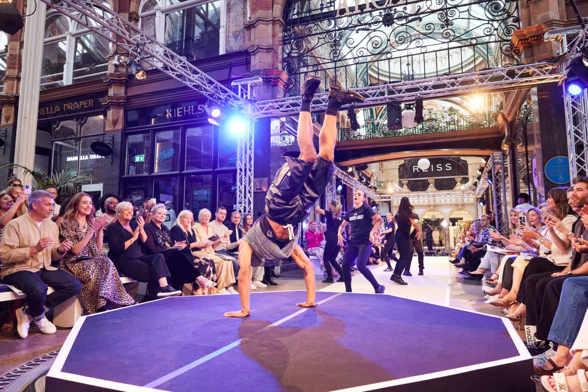 Handstand performance at Victoria Leeds Fashion Week 2026, showcasing dynamic street style and athle.