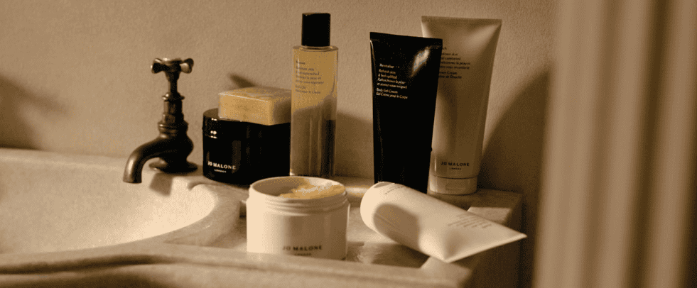 Luxurious skincare products displayed on a bathroom sink at Victoria Leeds.