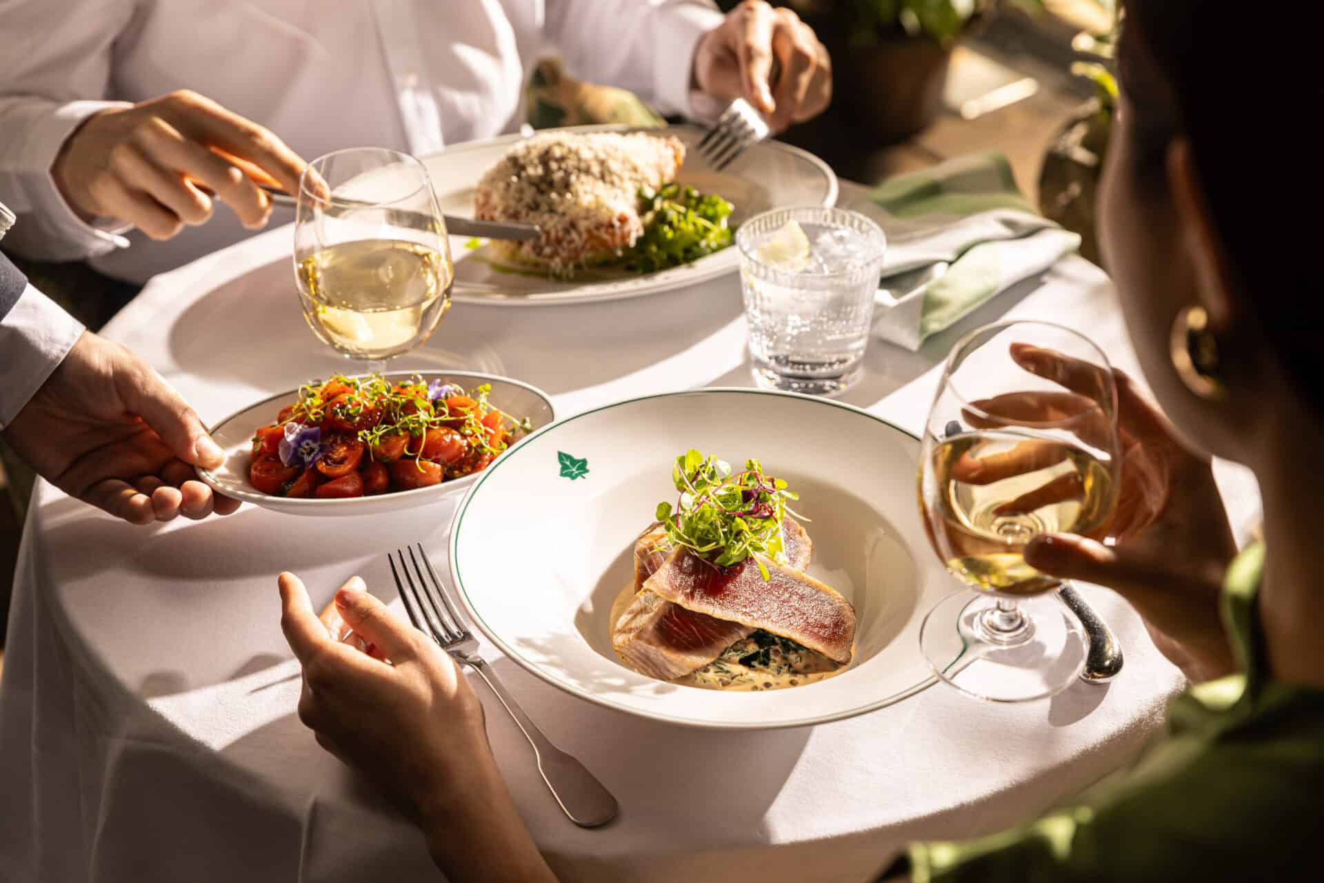 Elegant dining scene with gourmet dishes and wine at Victoria Leeds.
