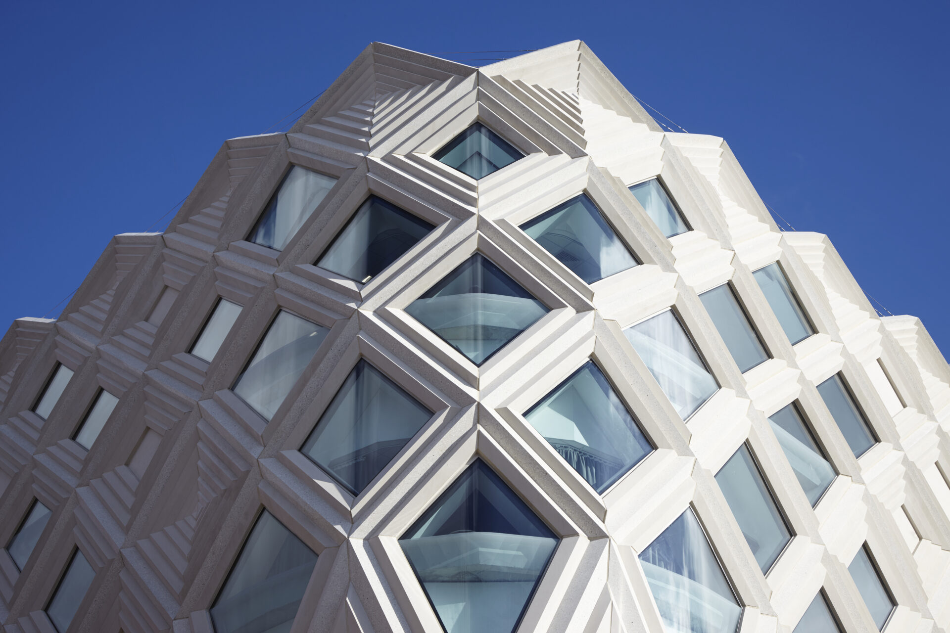Modern architectural building at Victoria Leeds with geometric design and glass windows.