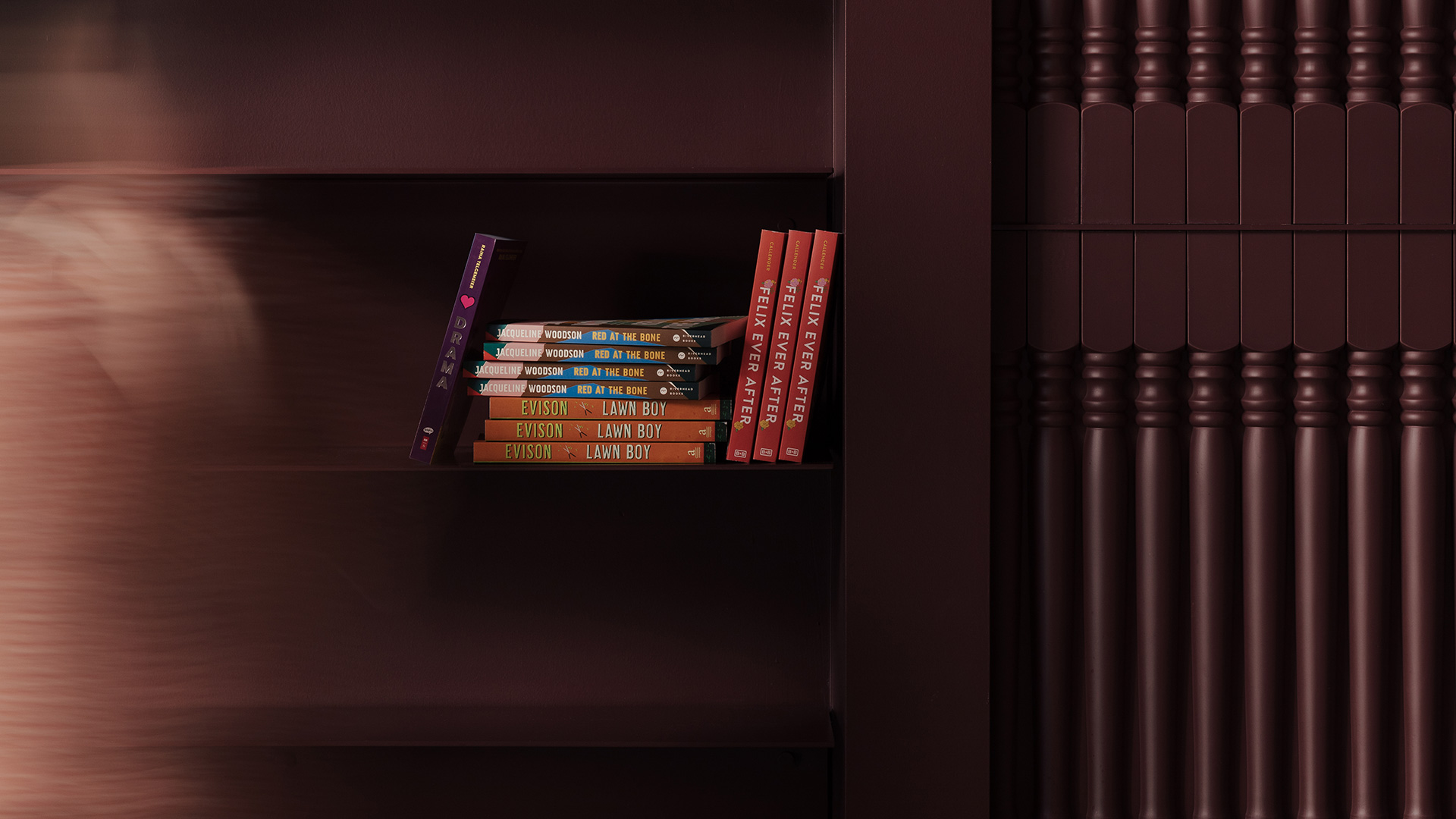 Books on a dark wooden bookshelf in the Aesop Reading Room.