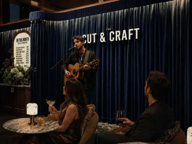 Musician performing at The Cut & Craft during Sunday acoustic session.
