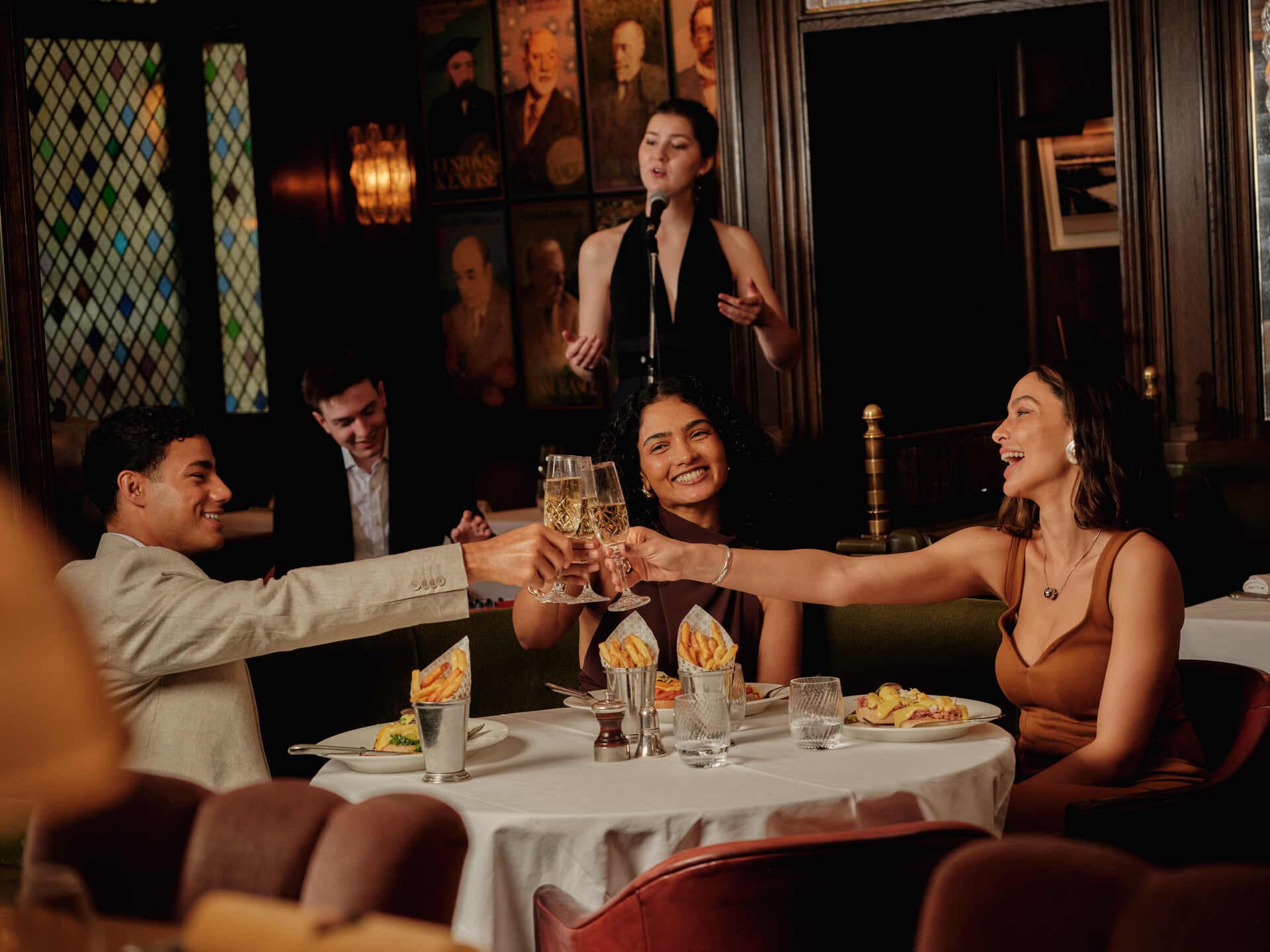 Group of friends enjoying drinks and food at Victoria Leeds during summer.