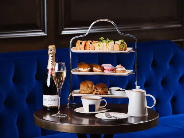Elegant afternoon tea setup with sandwiches, scones, and tea at Victoria Leeds.